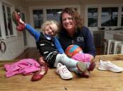 GONE VIRAL: The Rock Yerong Creek netballer Hazel Flinn with mother Katherine after a picture of the four-year-old went viral this week. Picture: Les Smith