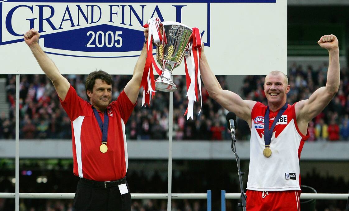 TRIUMPHANT: Sydney Swans coach Paul Roos and skipper Barry Hall hoist the AFL premiership cup after beating West Coast in the 2005 grand final. Picture: Getty Images