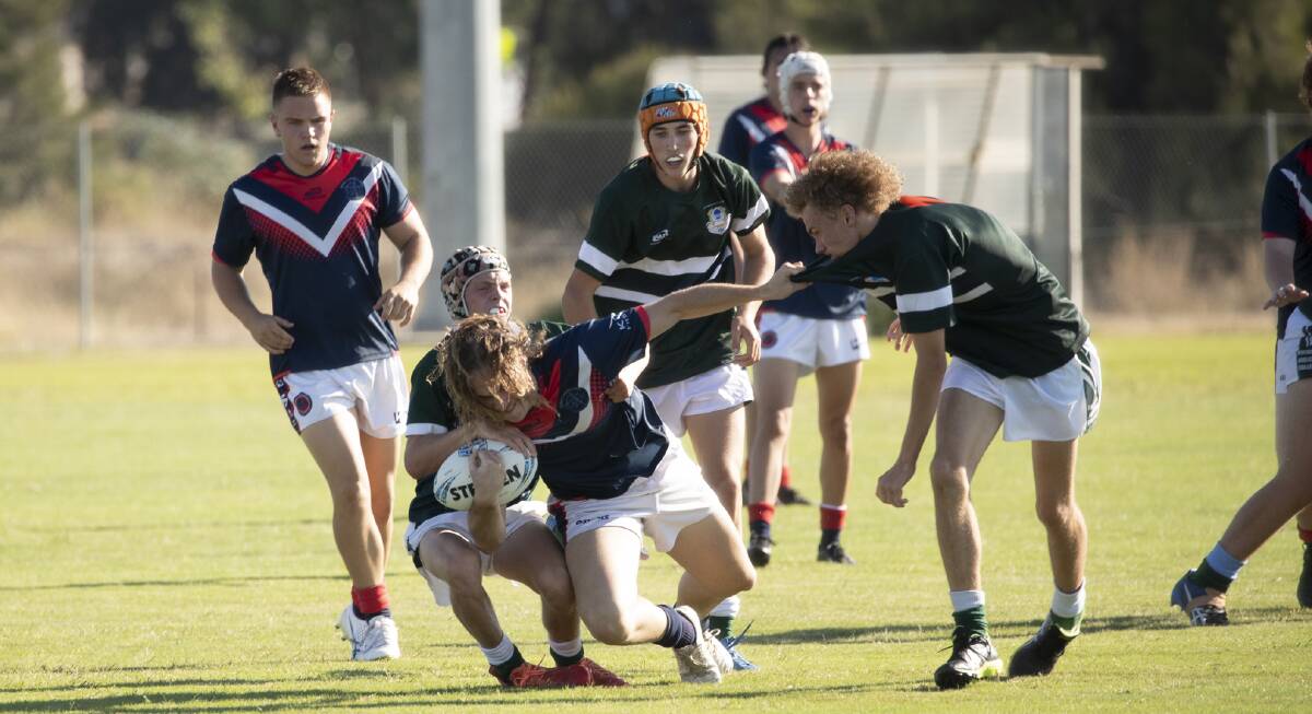 TOO STRONG: Kildare Catholic College second rower Joe Morton is tackled by The Riverina Anglican College's Angus Beggs during Monday's Hardy Shield action. Picture: Madeline Begley 