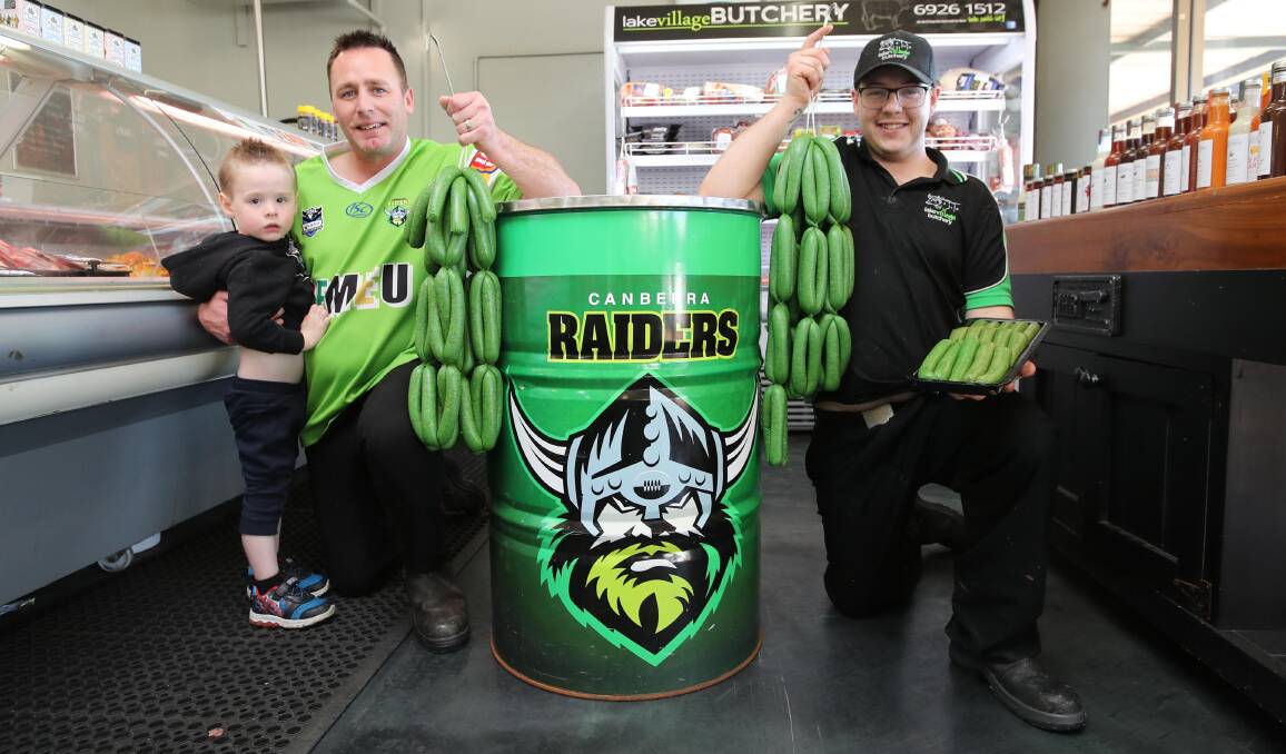 EAT YOUR GREENS: Lake Village Butchery boss and Canberra Raiders fan Nathan Trinder with son Brax and butchery manager Joshua Watson. Picture: Les Smith