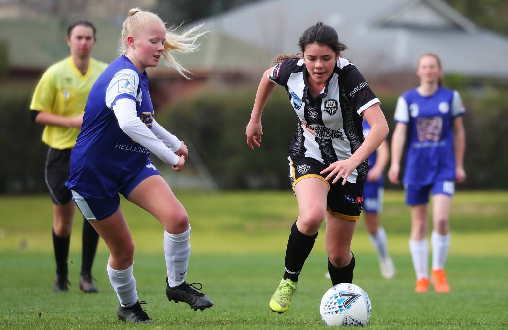 SEASON NEAR?: Wagga City Wanderers' Tess Vaccari takes on a Canberra Olympic defender during an under-17 game last year. Picture: Emma Hillier