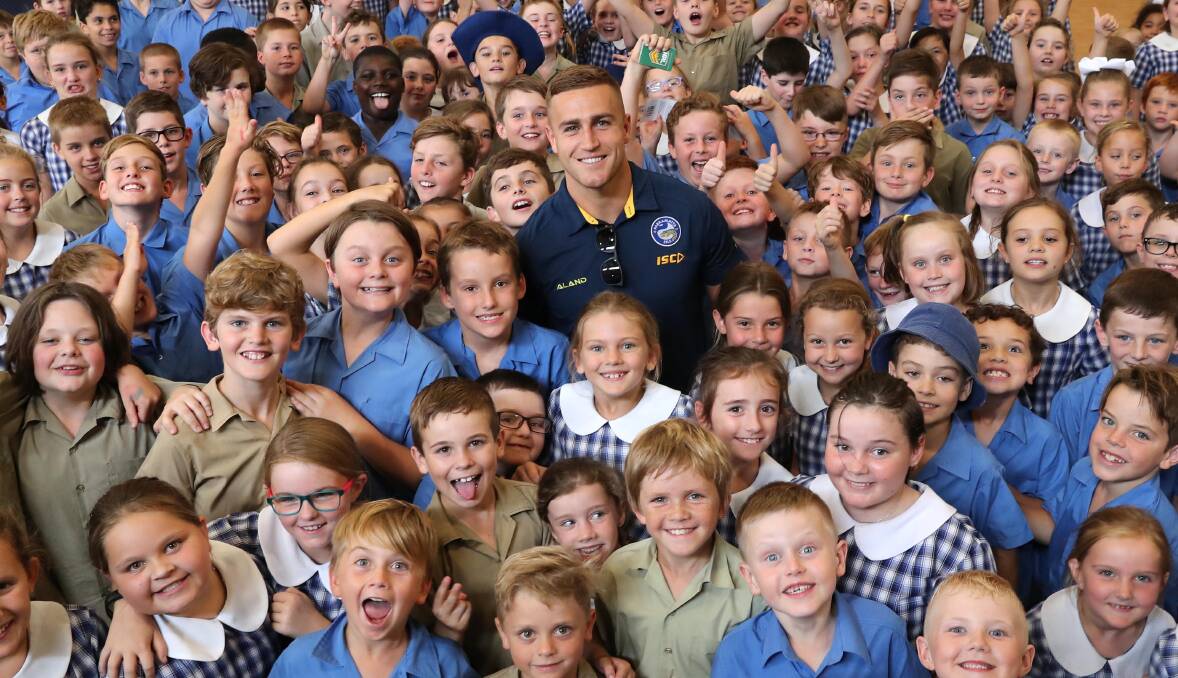 INJURY BLOW: Wagga product Cameron King, pictured visiting Sacred Heart Primary School in 2018 suffered a season-ending knee injury in a trial match for Cronulla. Picture: Les Smith