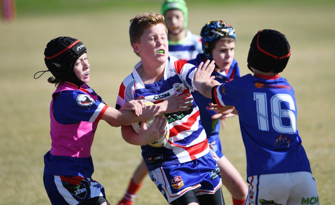 CHANGES AHEAD?: Young's Nicholaus Bailey tries to fend off a tackler during a junior rugby league match last year. Queensland is bringing in tackle bans extending to late in the under-sevens system. 