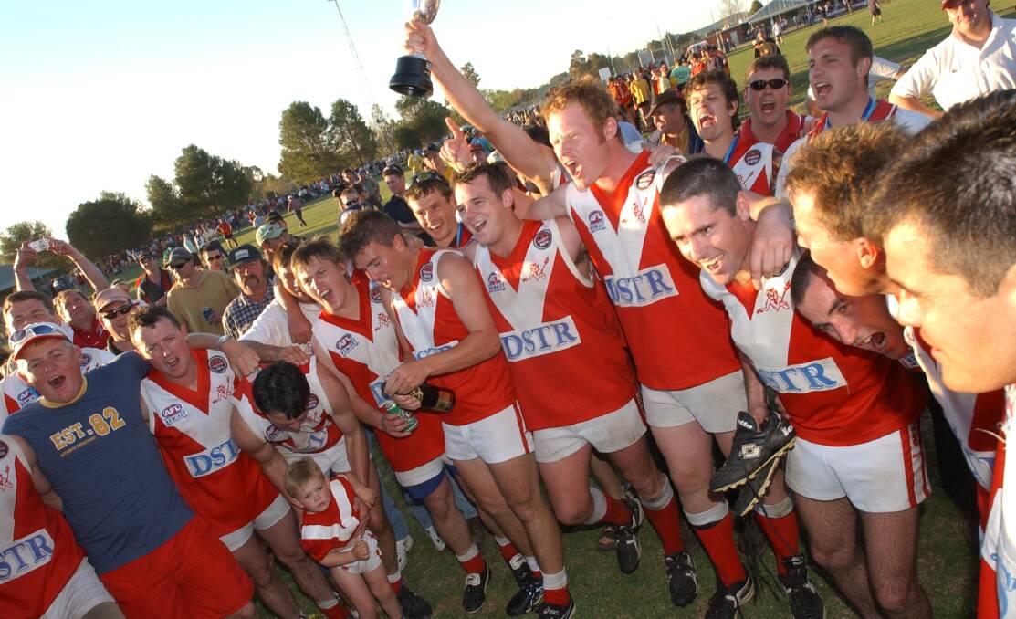 JUBILANT: The Demons let the team song rip after the 2002 grand final win. Picture: Kiley Blatch