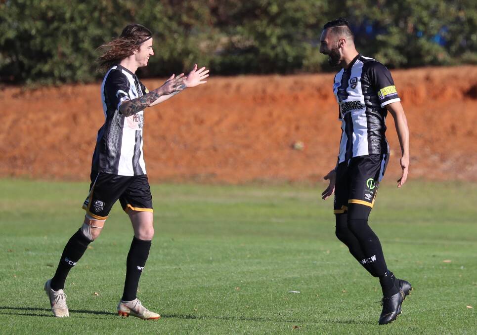 WINNING FEELING: Freddie Gardner (right) celebrates after scoring early in Wagga City Wanderers' 3-1 win over ANU on Saturday. Picture: Les Smith