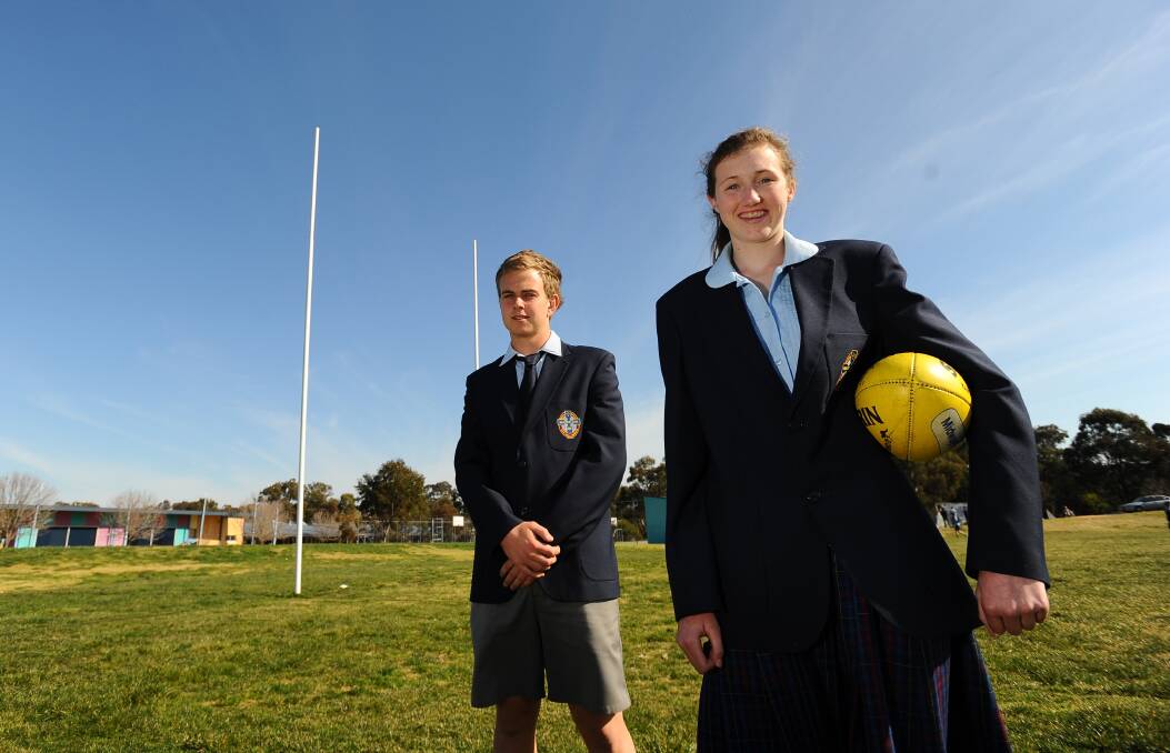 FOOTY LESSON: Rebecca Miller with former Mater Dei classmate Jim Carroll after excelling at the national championships in 2011. Picture: Addison Hamilton
