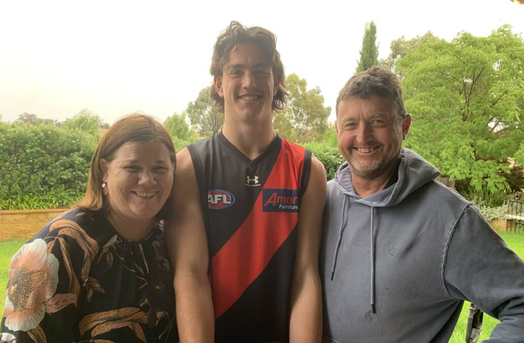 HAPPY DAYS: Patrick Voss with mother Maryanne and father Phil on Friday. Picture: Jon Tuxworth