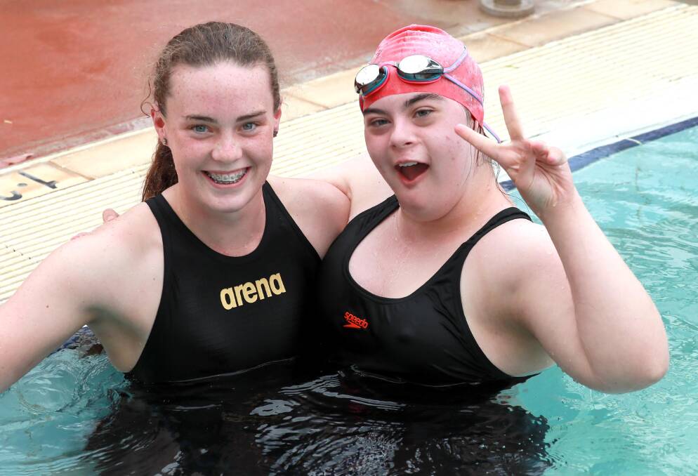 TEAM EFFORT: 17-year-old Gretta Leigh-Cooper completed the 50m freestyle at Mater Dei Catholic College's swimming carnival on Thursday, and has been coached by the one of the school's leading swimmers Annabella Storer. Picture: Les Smith 