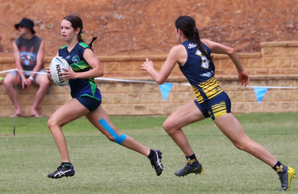 SUCCESSFUL CARNIVAL: Jorja Pinney tries to evade a Sydney Uni defender during an under-18 girls match at the Junior State Cup Southern Conference at Jubilee Park on Saturday. Picture: Emma Hillier