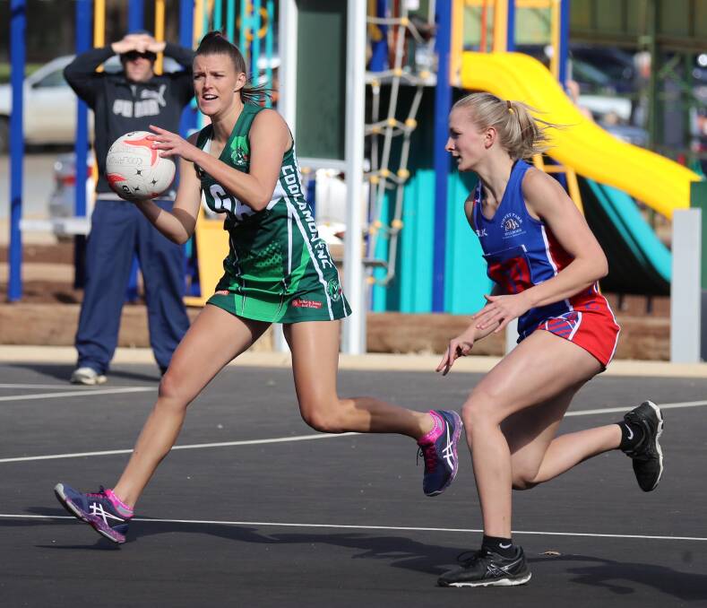 STRONG GAME: Coolamon's Sarah Hooper (with ball) is defended by Turvey Park's Alex Byrne during the Hoppers' 47-25 win. Picture: Les Smith.