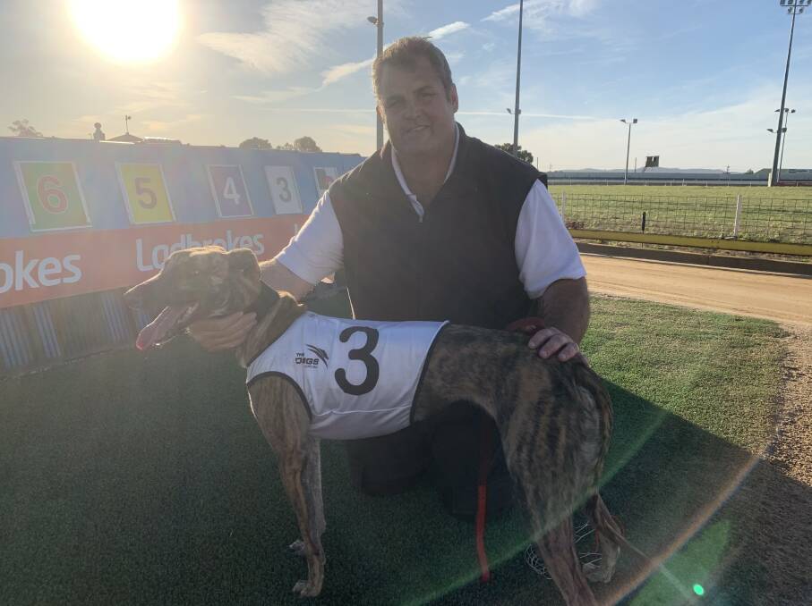 EMOTIONAL WIN: Ben Talbot with Winlock Molly after her win at Wagga Greyhound Club on Sunday. Picture: Jon Tuxworth