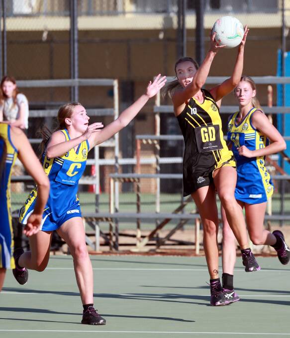 RIVALRY CONTINUES: Wagga Tiger Jess Allen takes a pass in front of Mangoplah-Cookardinia United-Eastlakes' Phoebe Wallace on Saturday. Picture: Les Smith