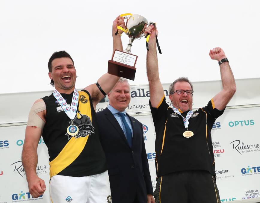 MEMORIES: Wagga Tigers skipper Lahn Shepherd and outgoing coach Troy Maiden the AFL Riverina Championship cup aloft after beating Leeton-Whitton in last month's grand final. Picture: Les Smith