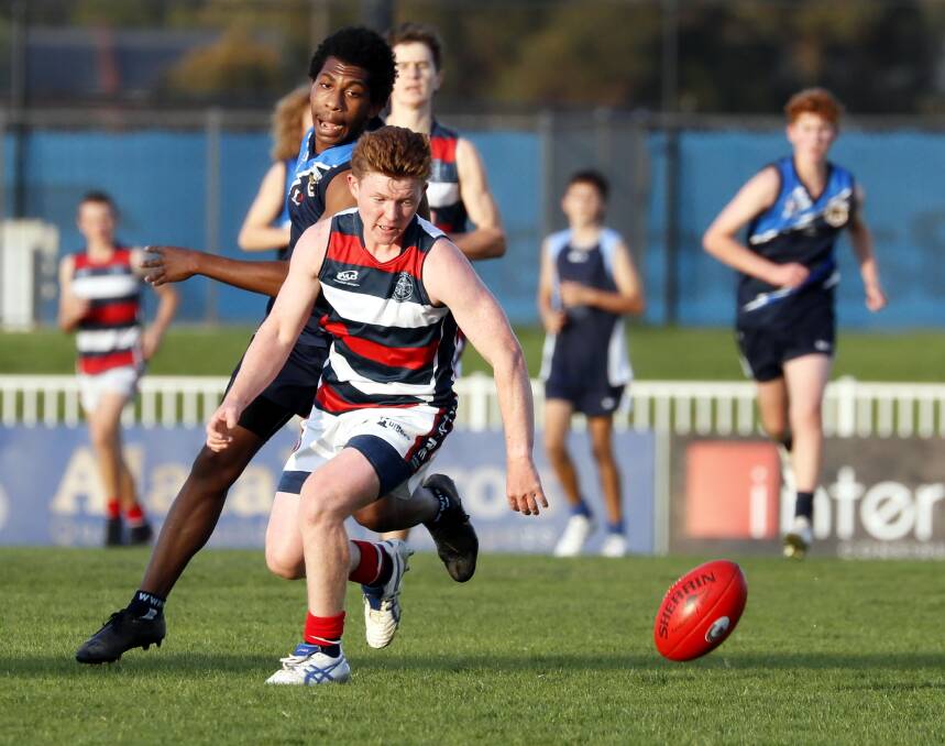 TOO CLASSY: Kildare Catholic College's Jackson Connolly and Wagga High's Lucas Brett hunt the ball during Wednesday's Carroll Cup clash. Picture: Les Smith