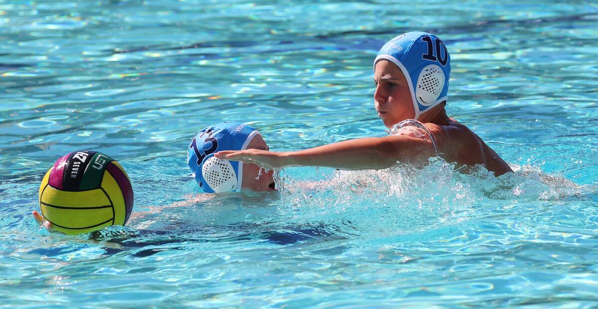 VALUABLE TIPS: Jock Graham and Ben Devries jostle for the ball during the weekend's water polo development camp in Wagga. Picture: Emma Hillier

