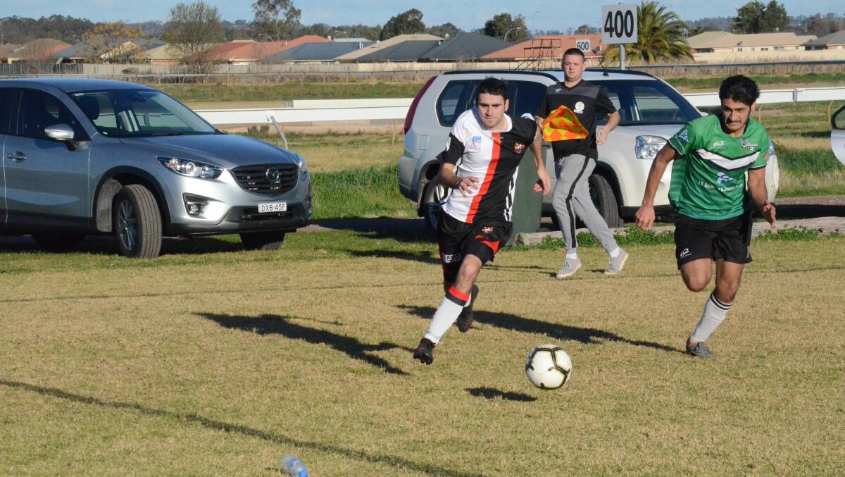 BIG WIN: Leeton's Macauley Harrison takes on a South Wagga defender during his team's 5-2 win on Saturday. Picture: Liam Warren 