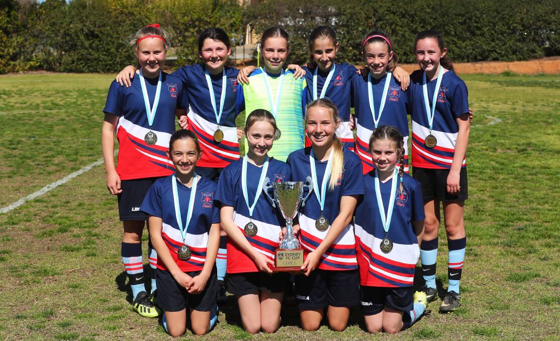 VICTORIOUS: The Mater Dei Primary School girls team with the Sydney FC Cup. Picture: Emma Hillier