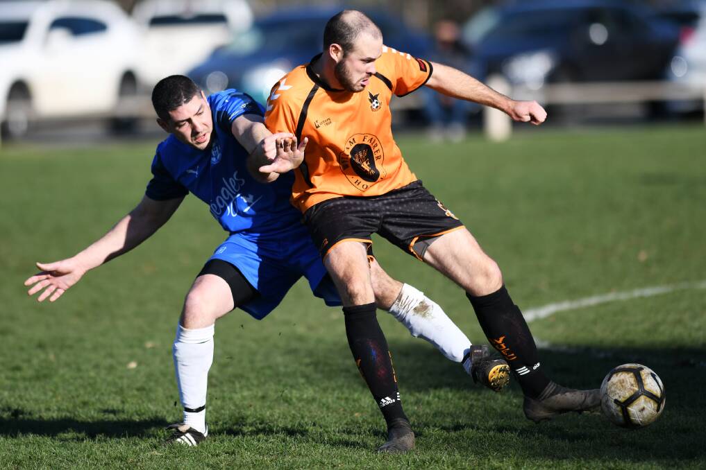 HANWOOD WIN: Hanwood's Matthew Napoli and Wagga United's Chris Walker battle for the ball at Rawlings Park on Sunday. 