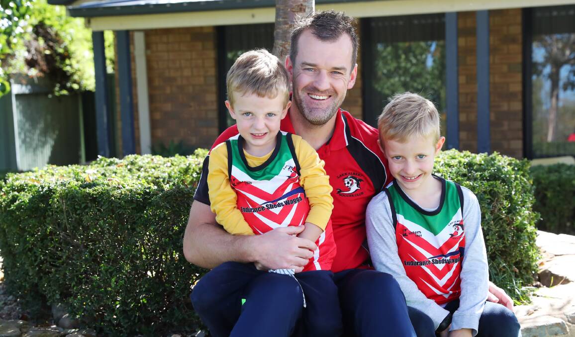 BACK IN FOLD: Justin Curran, pictured with sons Hugh, three, and Xavier, six, will return for Lake Albert this season after a stint with Wagga City Wanderers. Picture: Emma Hillier