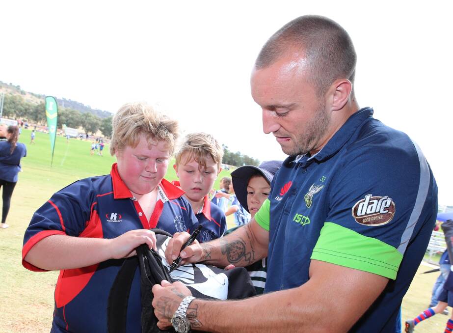 UP CLOSE: Raider co-captain Josh Hodgson signs an autograph for Sacred Heart's Kade Coster at the Mortimer Shield on Thursday. Picture: Les Smith