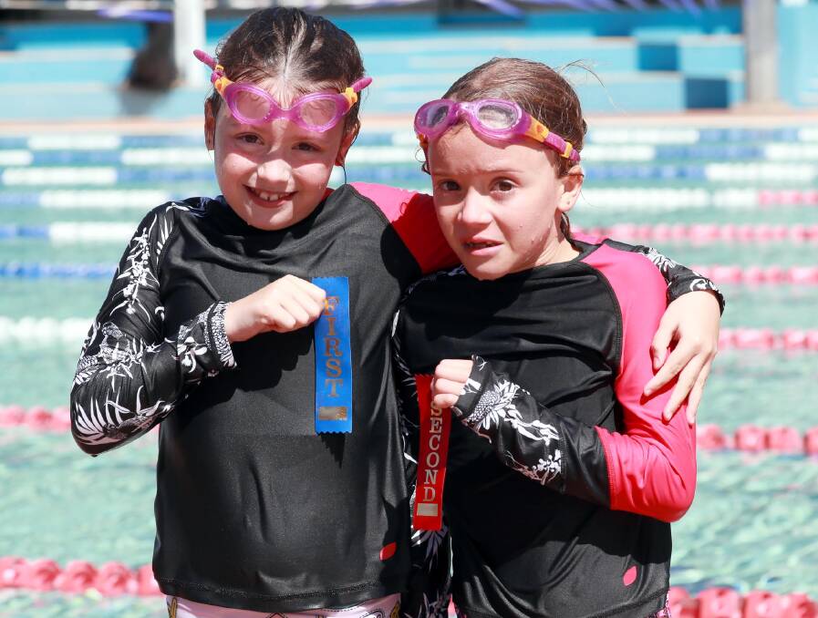 SUPER SIBLINGS: Laine Griffith and twin sister Florence finished first and second in the ten years girls 50m backstroke at Red Hill Public School's swimming carnival. Picture: Les Smith