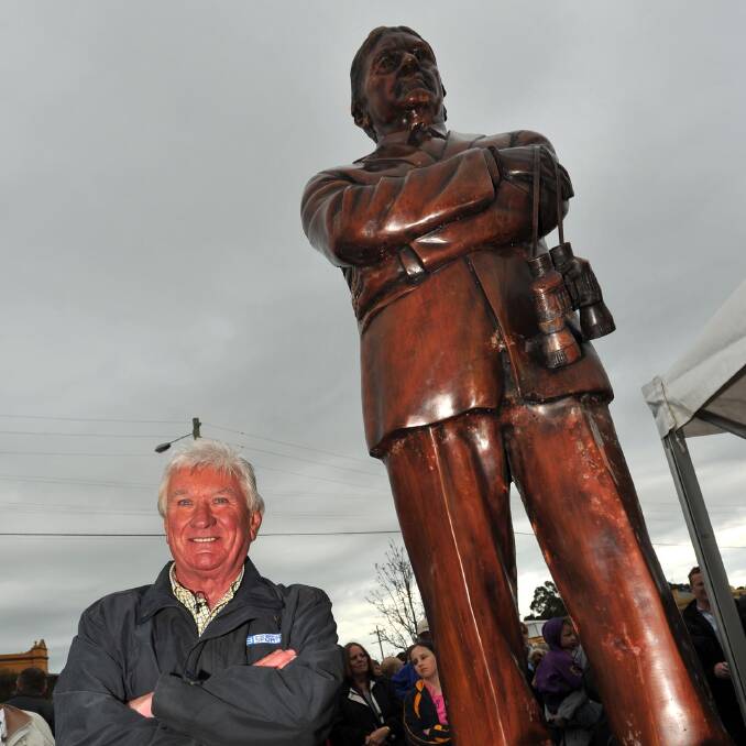Ray Warren alongside his statue after it was unveiled in 2011. Picture: Declan Rurenga