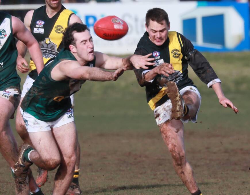FINALS BOUND: Wagga Tiger Nick Ryan gets a kick away under pressure from Coolamon's Ryan Allen during a Riverina League clash this year. Picture: Les Smith