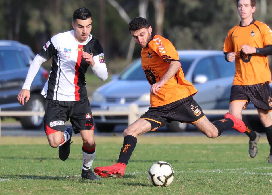 DANGEROUS: Wagga United striker Nazar Yousif takes on Leeton United's Nick Trifogli during the Crows' 1-0 victory yesterday. Picture: Les Smith.