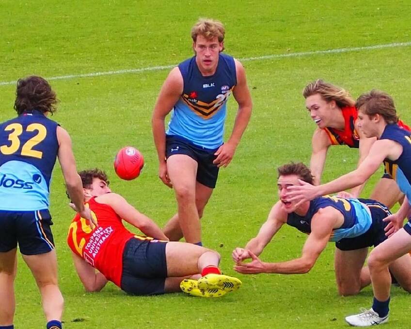 HARD BALL GET: Luke Fellows gets a clearance as Harvey Thomas (right) watches on during NSW/ACT Academy's win over South Australia in Adelaide on the weekend. 