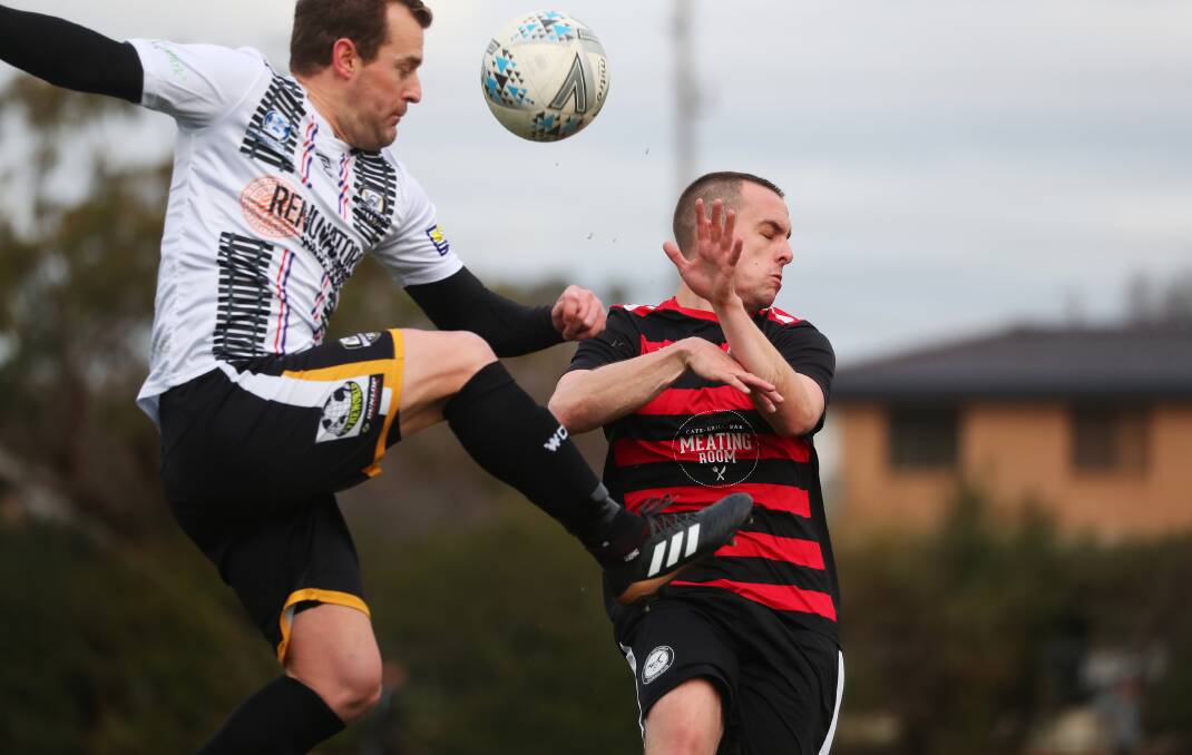 SOCCER DUEL: Wagga City Wanderers' Justin Curran takes on Weston Molonglo's Jarryd Clifton during Saturday's scoreless draw at Gissing Oval. Picture: Emma Hillier