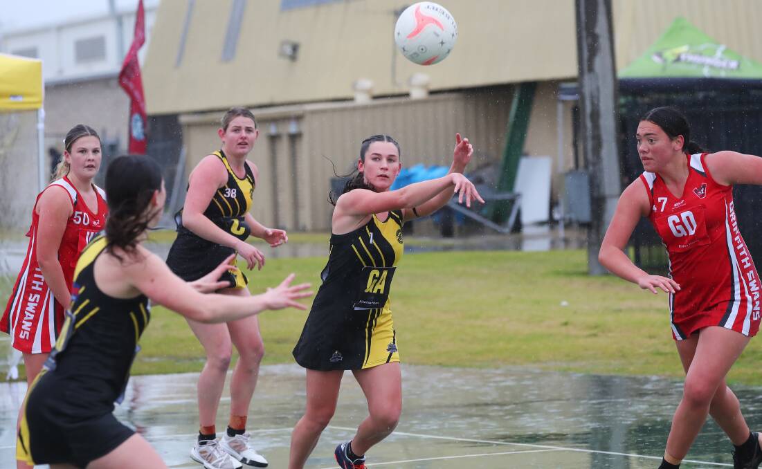 DAMP: Wagga Tiger Eliza Kelly finds a teammate during Saturday's wet clash with Griffith at Robertson Oval. Picture: Emma Hillier
