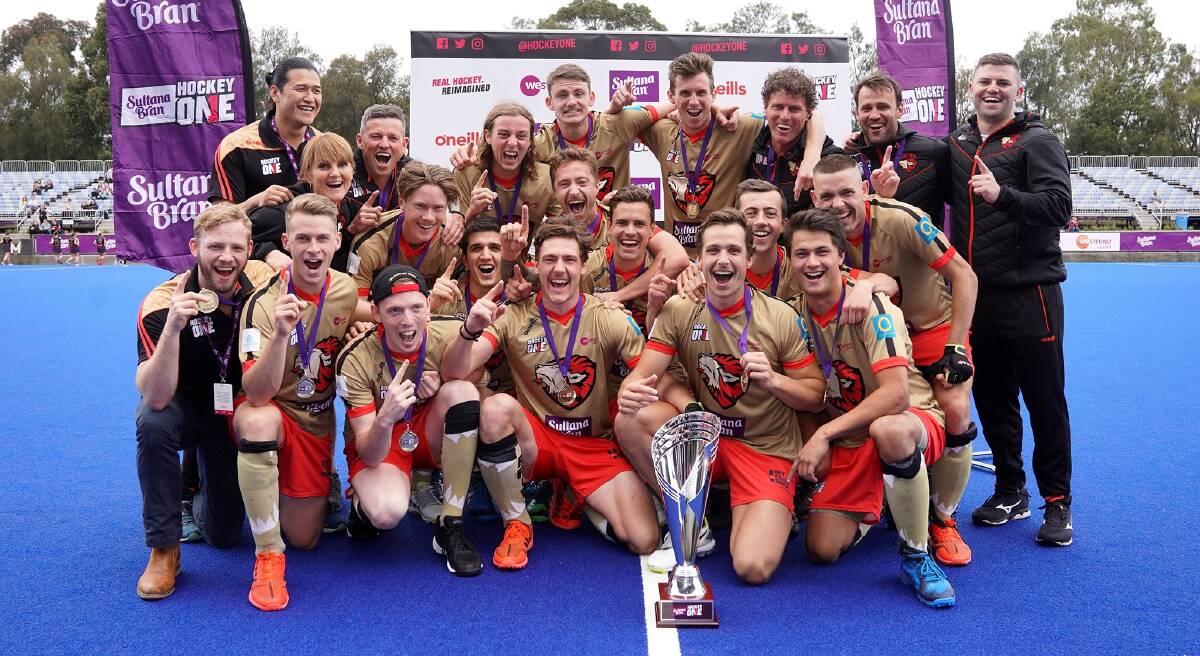 INAUGURAL WINNERS: Wagga's Dylan Martin, (back, centre) helped NSW Pride claim the Hockey One title with victory over Brisbane in Saturday's final. Picture: NSW Pride