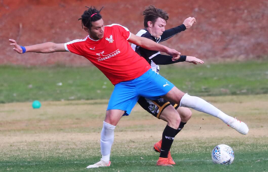 TOUGH LOSS: Canberra White Eagles' Zinelabiddine Elijammoudi and Wagga City Wanderers' Shaun Moffat do battle at Gissing Oval on Saturday. Picture: Emma Hillier.
