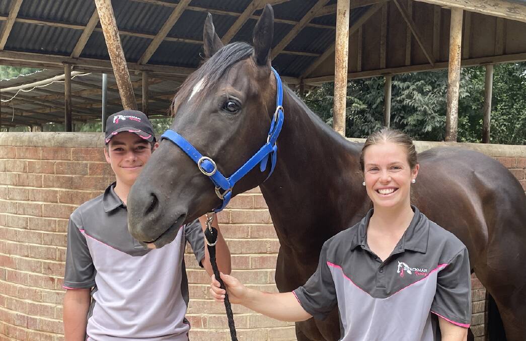 BACK ON TRACK: Strappers Oliver Spackman and Emily Waters with Rocket Tiger, who will return to racing after a year off at Flemington on Saturday. Picture: Jon Tuxworth