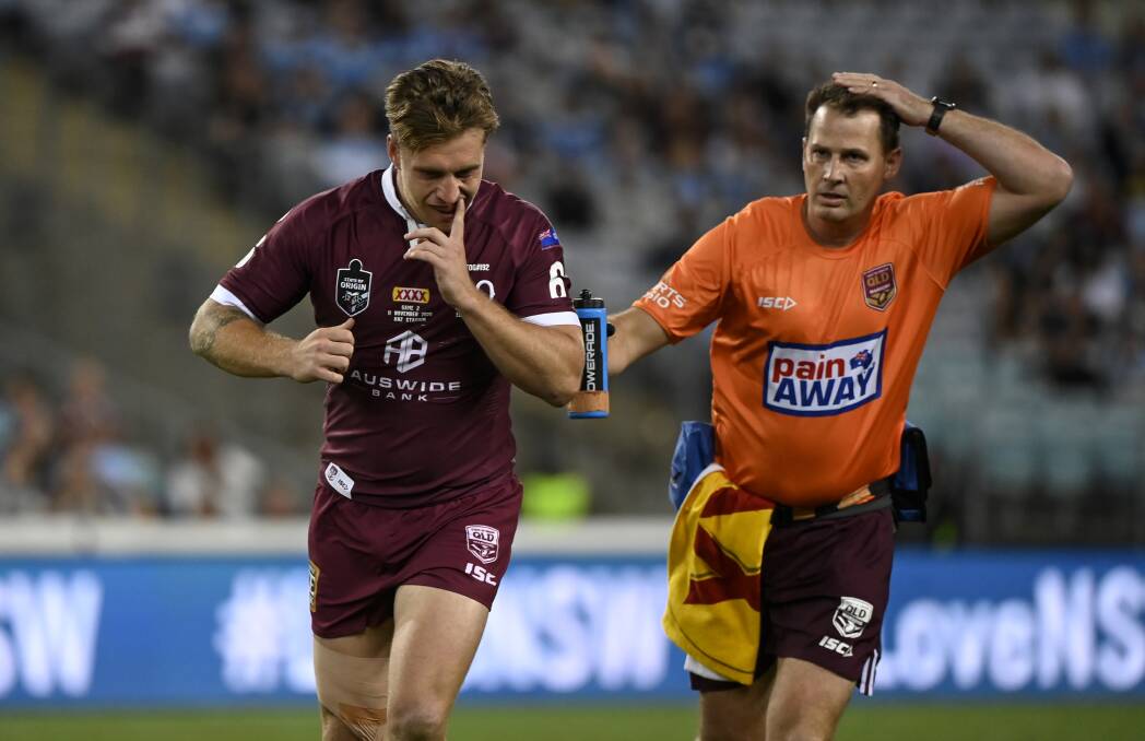 PRESSING ISSUE: Queensland five-eighth Cameron Munster leaves the field to undergo a concussion test early in Wednesday's loss to NSW. Picture: NRL Imagery/Grant Trouville

