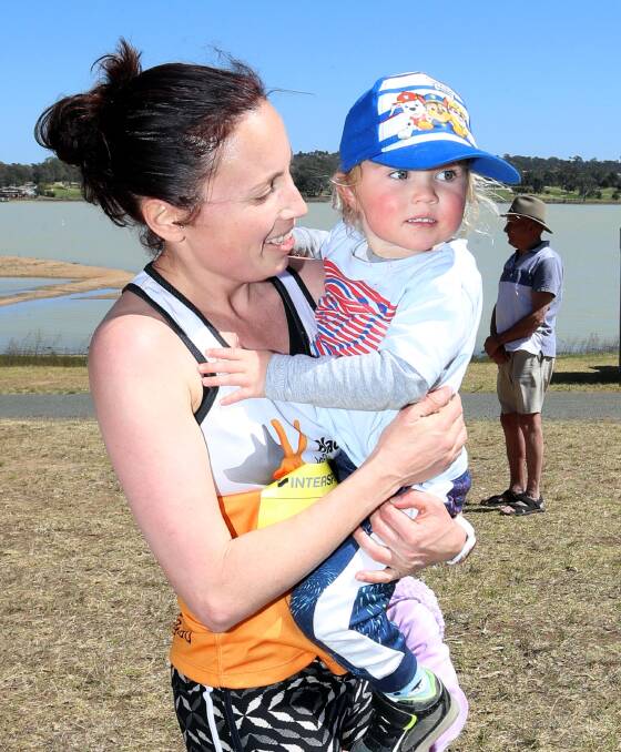 WOMEN'S CHAMPION: Women's 10km winner Sally Cassilles with son Theo, 2. Picture: Les Smith