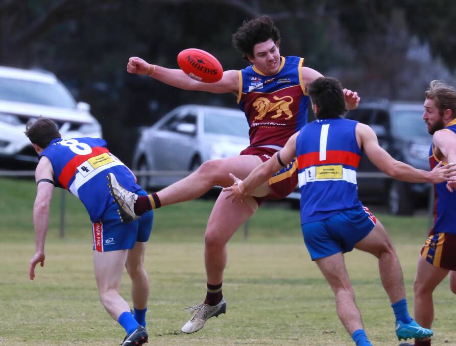 OUT INJURED: Riley Corbett gets a kick away during Ganmain-Grong Grong-Matong's round one win over Turvey Park. Picture: Les Smith