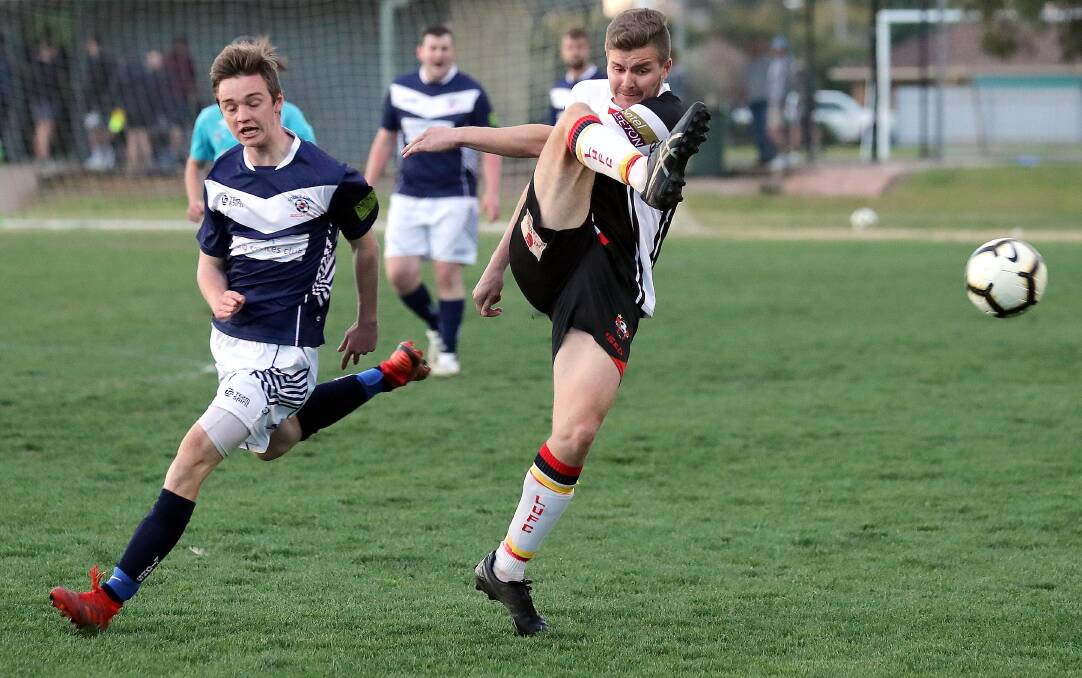 FINALS PUSH: Leeton United's Daniel McKenzie and Young's Isaac Anderson do battle during last year's Pascoe Cup elimination final clash. 