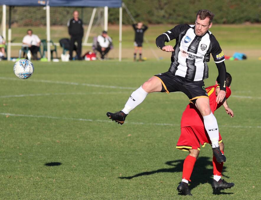 TOUGH LOSS: Wagga City's Justin Curran leaps for a header during Saturday's 1-0 loss to Queanbeyan. Picture: Les Smith. 