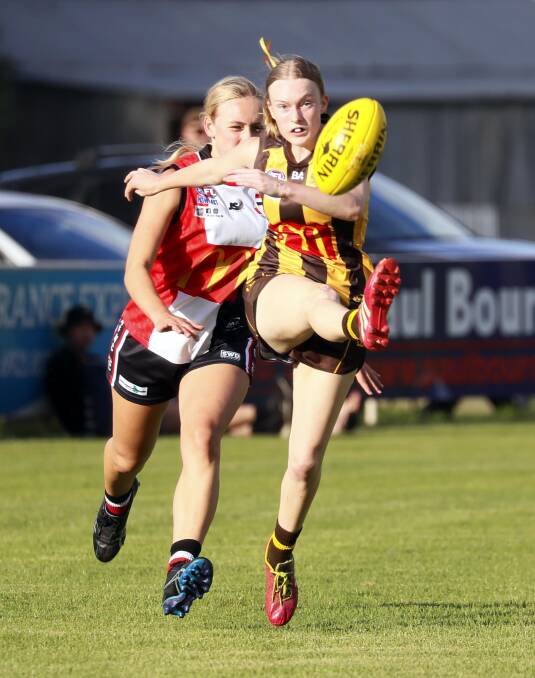 FOOTY'S BACK: East Wagga Kooringals' Jessica Wild gets a kick away with North Wagga's Liberty Skeers in hot pursuit. Picture: Les Smith