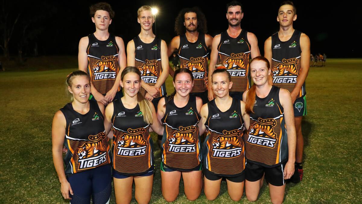 WINNERS ARE GRINNERS: Tigers celebrate after beating Storm 7-5 in the mixed premier league grand final on Tuesday night. 