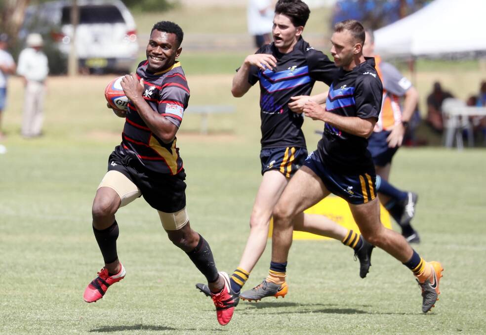 FLEET FOOTED: Tiko Autiko runs to score a try for
Naitasie Highlands Rugby during Saturday's inaugural
Waganha Waagangalang Sevens carnival at Conolly Park.
Picture: Les Smith