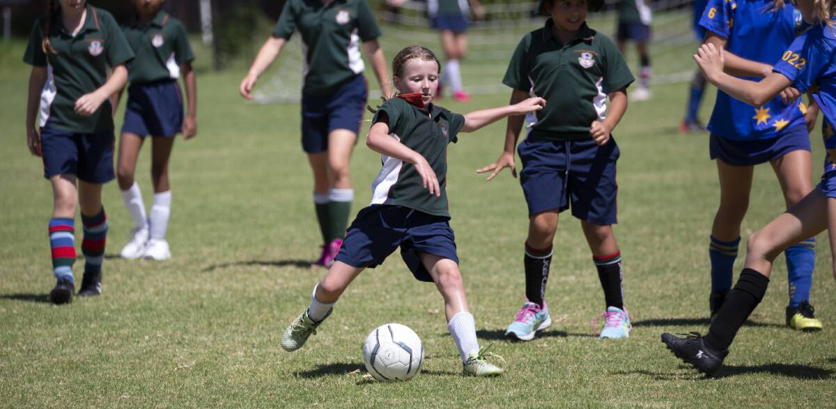 FUN TIMES: The Riverina Anglican College's Lucy Arentz taking part in a year five match against Lake Albert Primary at Football Wagga's gala day on Monday. Picture: Madeline Begley 