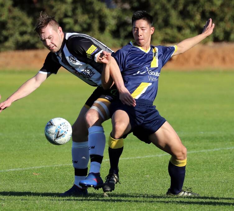 BIG WIN: Wagga City Wanderers' Jake Ploenges contests the ball with Southern Tablelands' Pak To Pang during Saturday's 6-0 win at Gissing Oval. Picture: Les Smith.