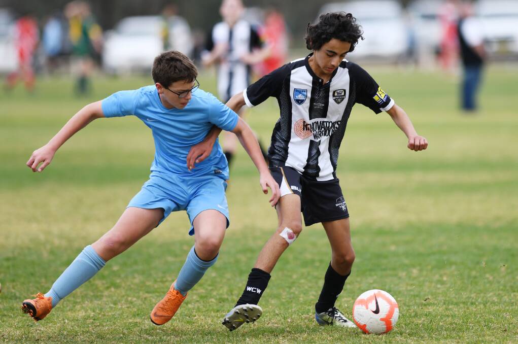 RISING STARS: Far South Coast's Dylan Watkins and Wagga's Samuel Seghabi battle for the ball during their 14 years boys Country Cup clash. 