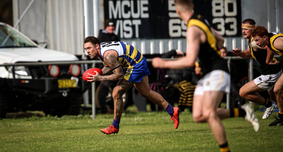 MAKING WAVES: Wagga Tigers' defender Justin Jenkins (far right) tries to chase down MCUE's Trent Castles last week. Picture: Justin Wiltshire/The Border Mail 