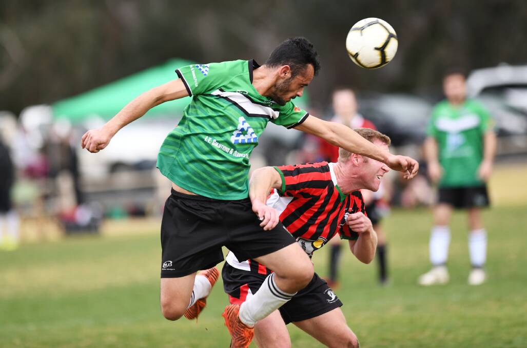 NEW ERA: Mazban Sulaiman heads a ball in front of Lake Albert's Duncan Brodie during a Pascoe Cup match this year. 