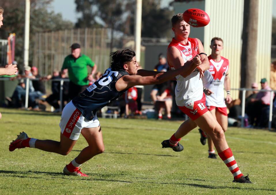 STANDOUT: Debutant Harry Wichman (left) tries to chase down Griffith's Riley Irvin during Saturday's round one match at Crossroads Oval. Picture: Les Smith