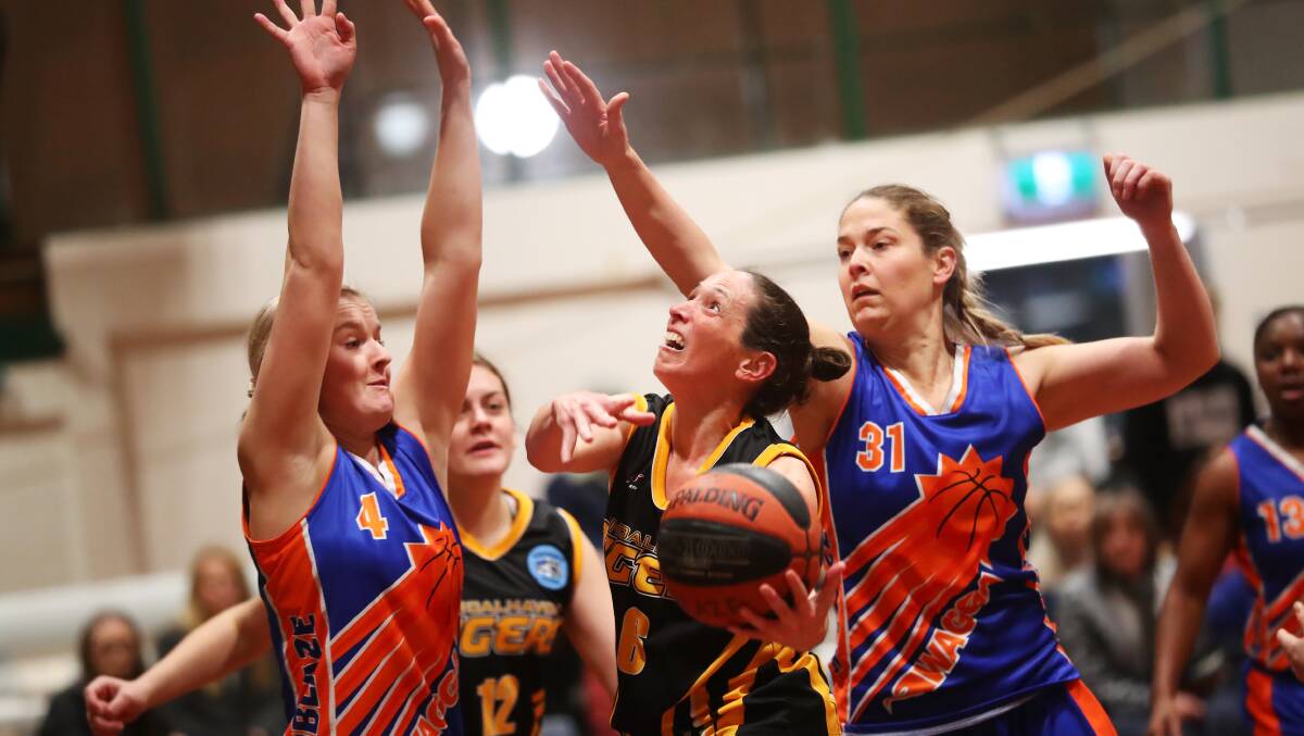 TOO STRONG: Wagga Blaze's Maddison Clyne and Caren Hugo defend Shoalhaven's Mary-Jane Toole during their big home win on Saturday. Picture: Emma Hillier 