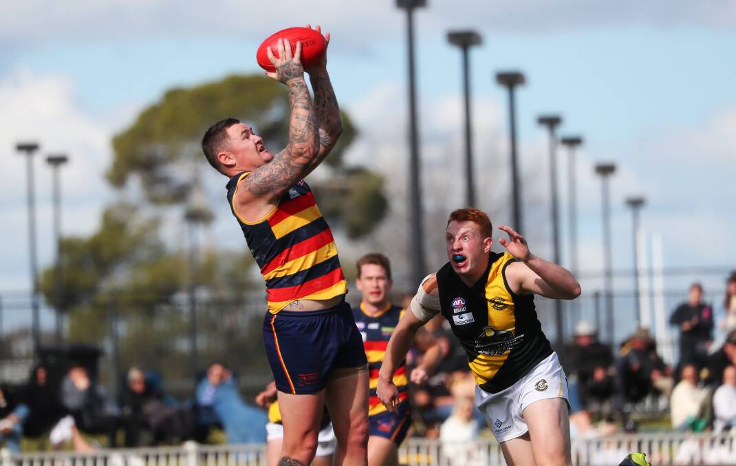 FINAL SHOWDOWN: Leeton-Whitton's Jade Hodge takes a mark in front of Wagga Tigers Justin Jenkins during the major semi. Picture: Emma Hillier